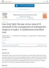 Low-Level Light Therapy Versus Topical 5% Minoxidil in the Management of Androgenetic Alopecia in Males: A Randomized Controlled Trial